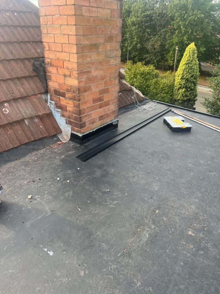 This is a photo of a flat roof which has just been repaired, there is also a chimney stack and some leadwork has also been dressed. Works carried out by MCM Roofing Repairs Warminster