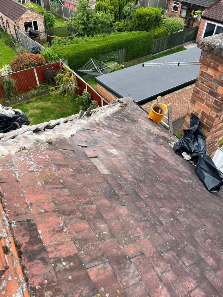 This is a photo of a roof where the hip tiles have been removed, and are just about to be replaced. Works carried out by MCM Roofing Repairs Warminster